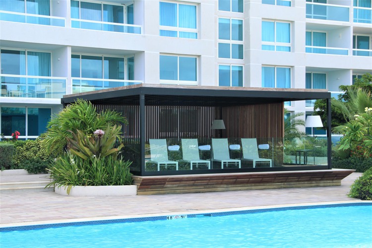 Enclosed seating area beside pool