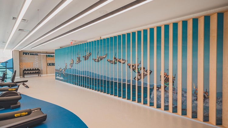 Fitness center and art on wall of man doing water sports