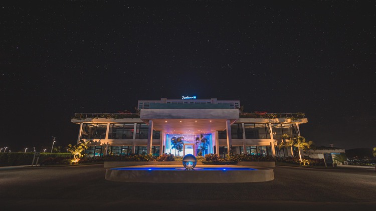 Front entrance to a building with colorful lighting