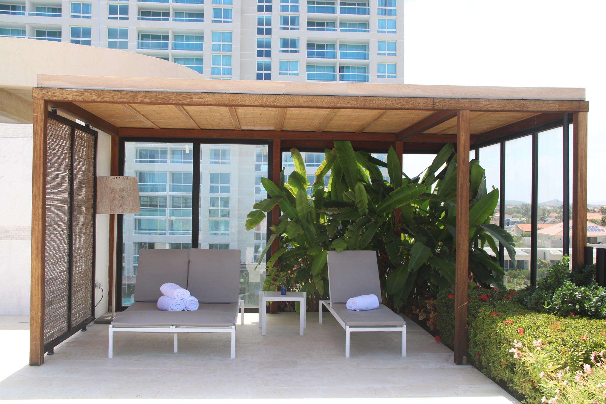 Covered seating area with towels and building in the background