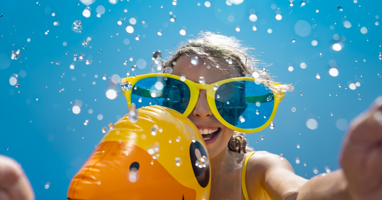 A girl wearing sunglasses underwater